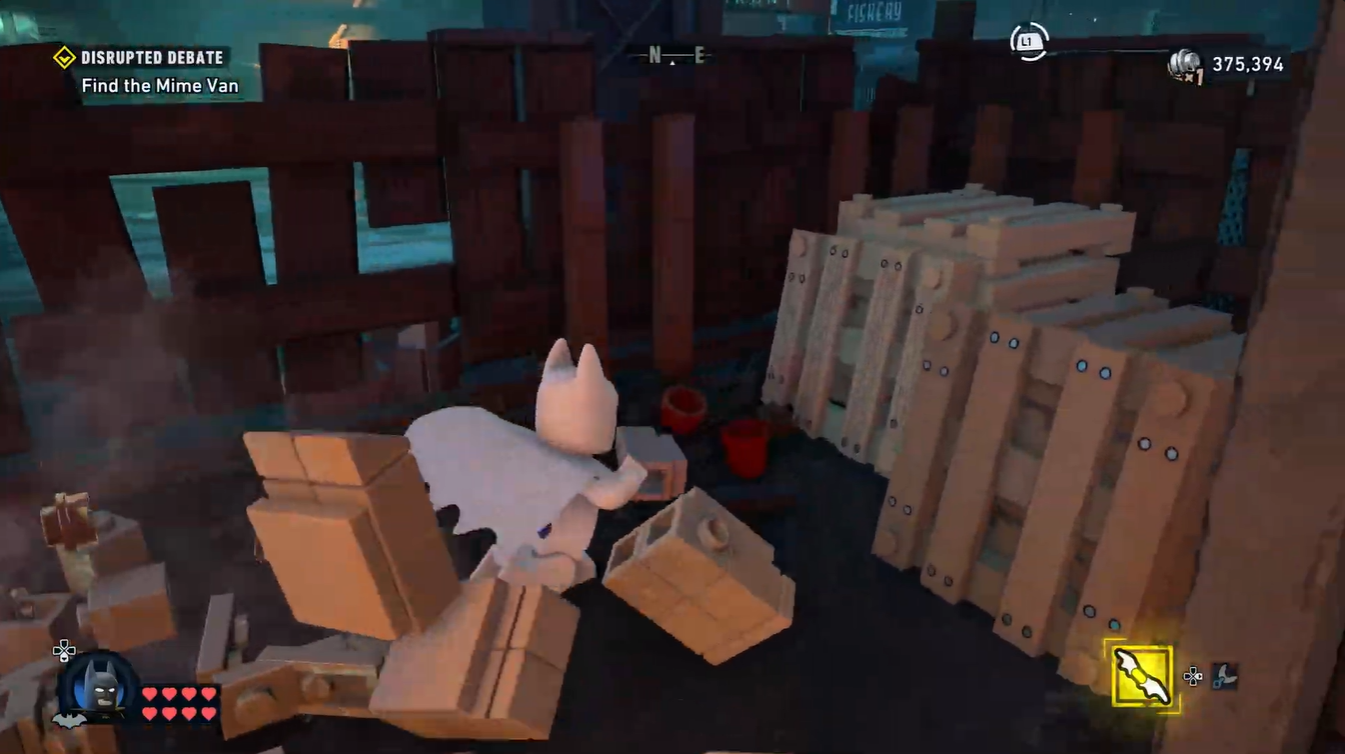 Batman breaking crates and debris near the foam-covered street in Disrupted Debate mission