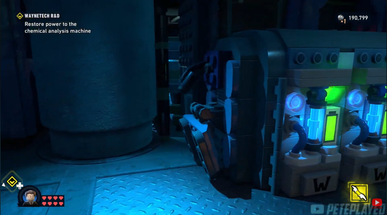 Batman interacting with the WayneTech bear analysis machine after restoring generator power in LEGO Batman: Legacy of the Dark Knight