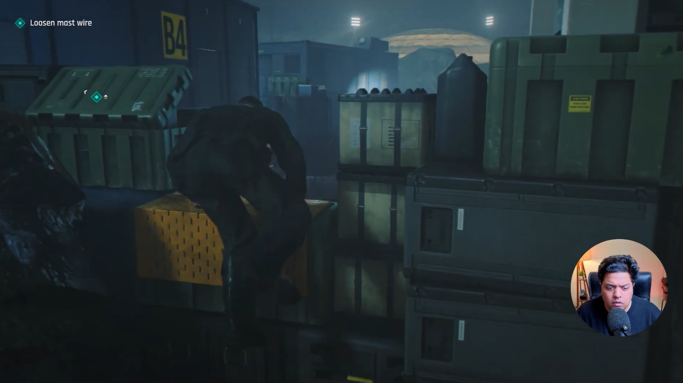 Bond climbing over stacked crates and containers to reach the mast wire location in the Against The Odds prologue mission.