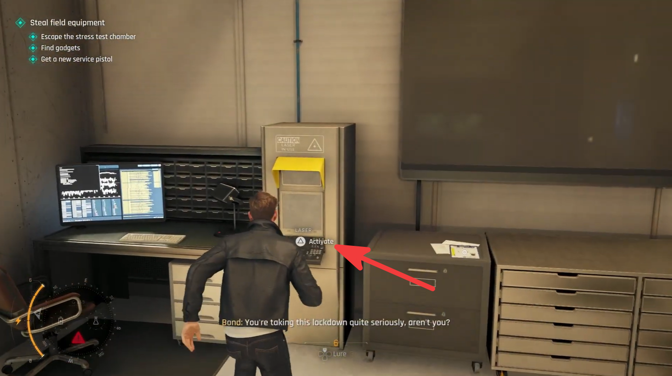 Bond standing beside the laser activation station, highlighting the equipment used to destroy the pressure-test machine block during the puzzle sequence.
