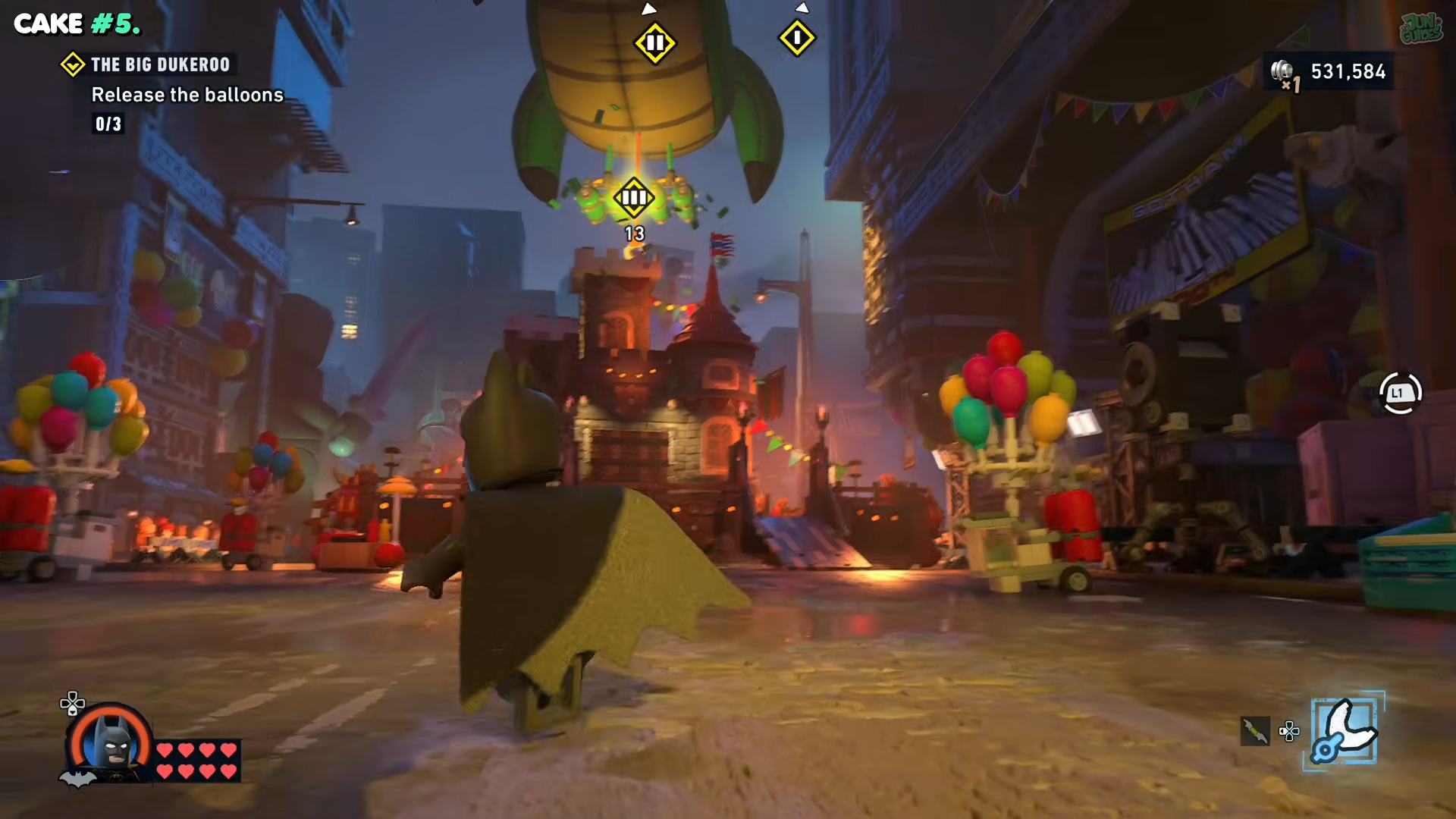 Batman walking past the third balloon in Lego Batman: Legacy of the Dark Knight