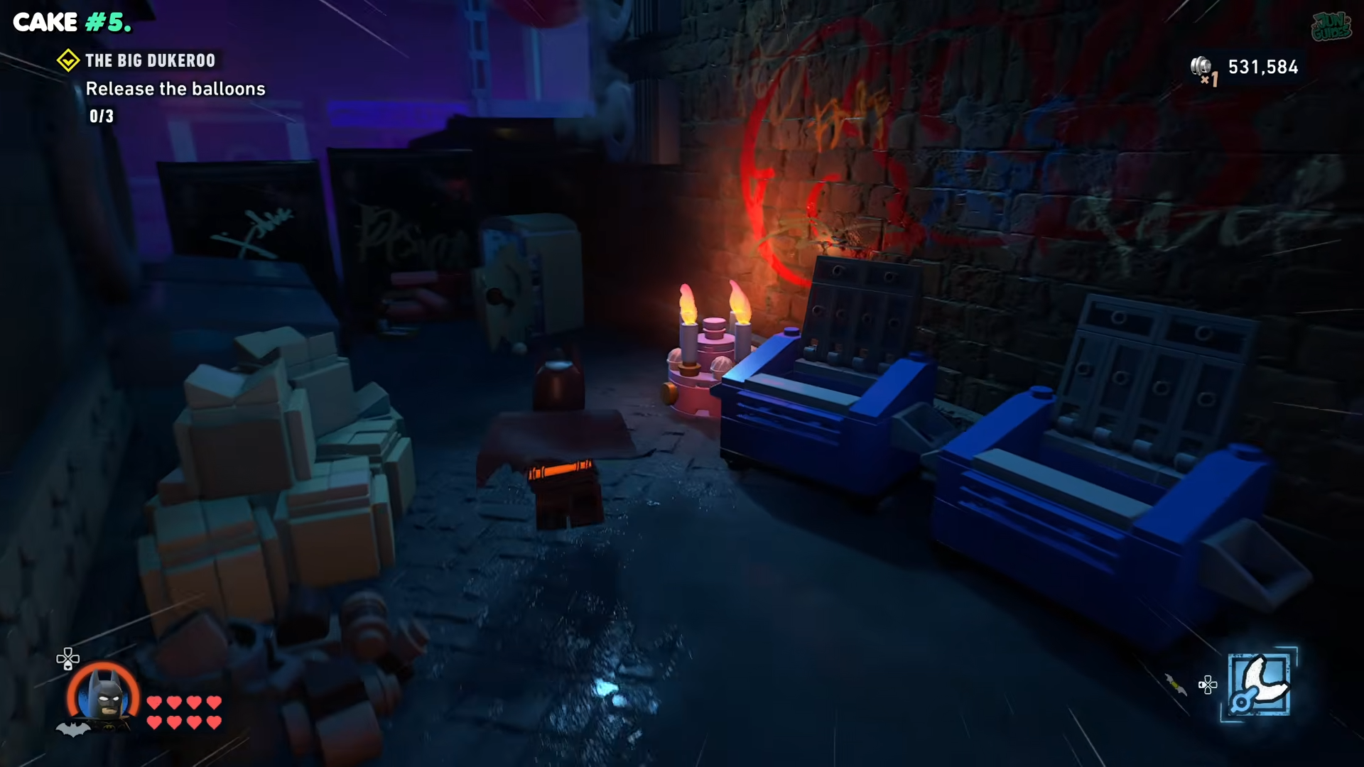 Batman looking at a pink cake at the end of a dark alley in the Big Dukeroo in Lego Batman: Legacy of the Dark Knight