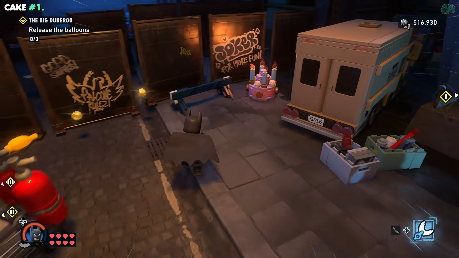 Batman looking at the cake next to a van in the Big Dukeroo in Lego Batman: Legacy of the Dark Knight