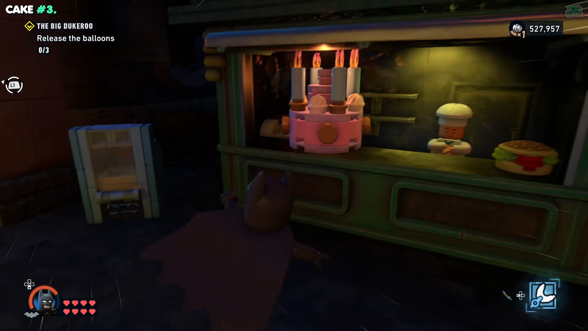 Batman looking at a pink cake in a shop in Lego Batman: Legacy of the Dark Knight 