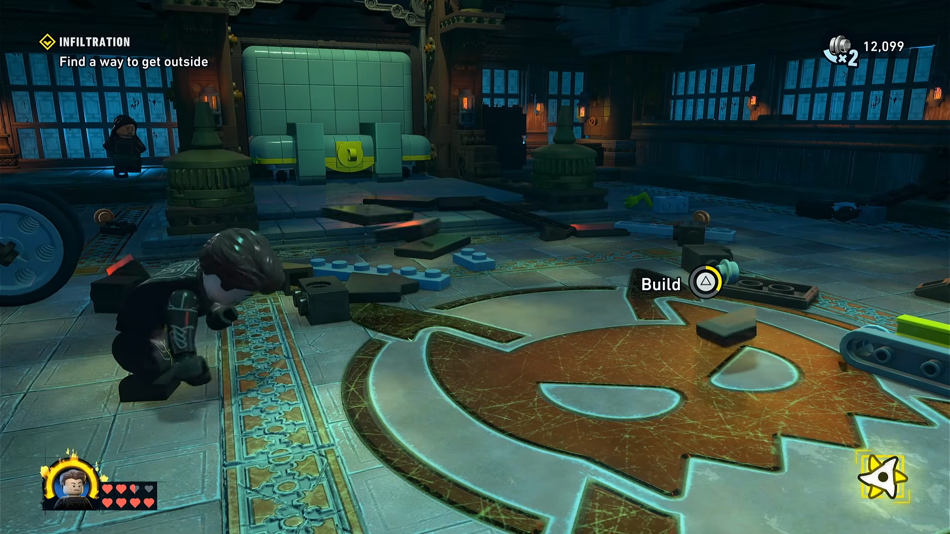 Close‑up of the LEGO pieces on the floor being rebuilt into a winch device ready to be attached to the wall in LEGO Batman: Legacy of the Dark Knight