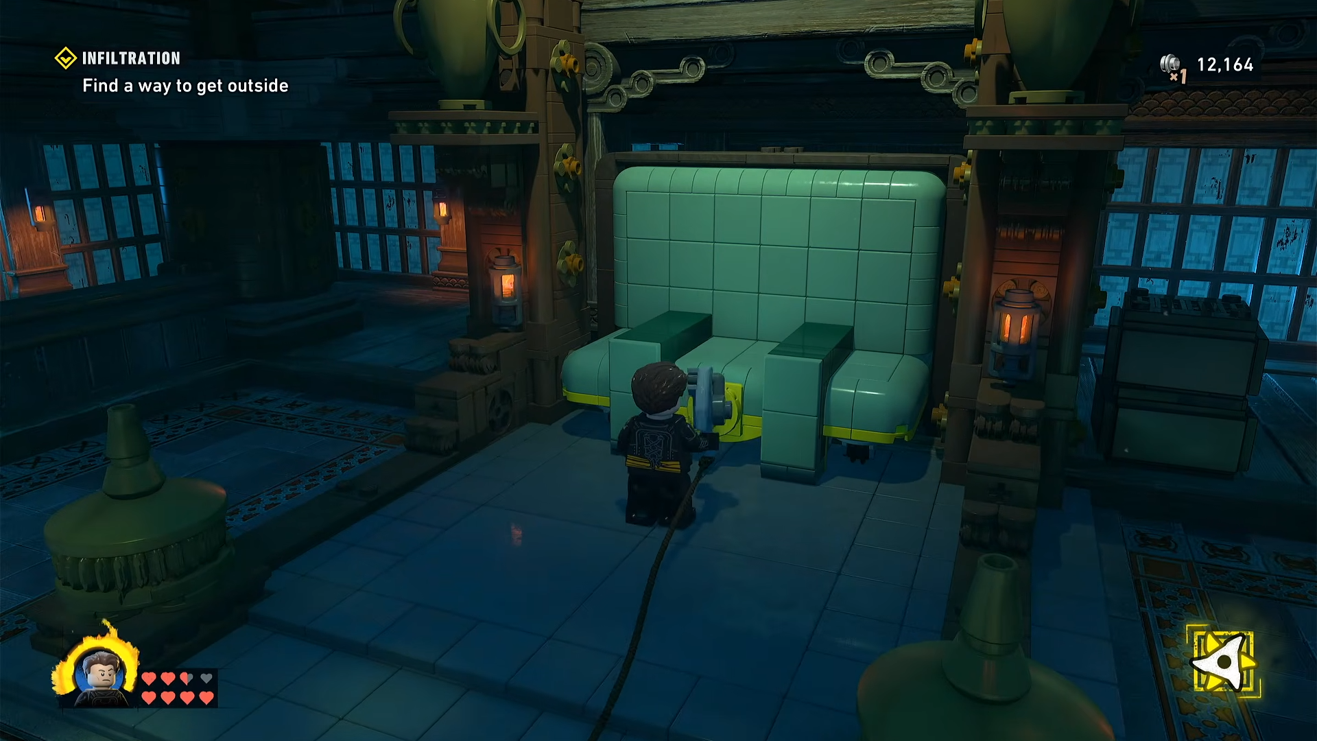 Winch anchored to a wall plate near a bed chained inside an alcove in the Infiltration mission LEGO Batman: Legacy of the Dark Knight