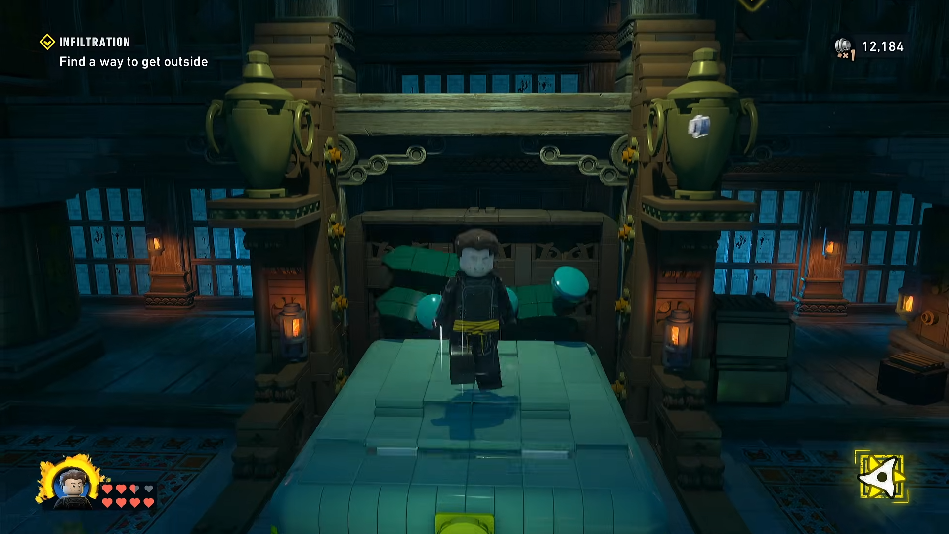 Batman repeatedly jumping on the pulled‑out bed to bounce high enough to reach the ledge above in LEGO Batman: Legacy of the Dark Knight