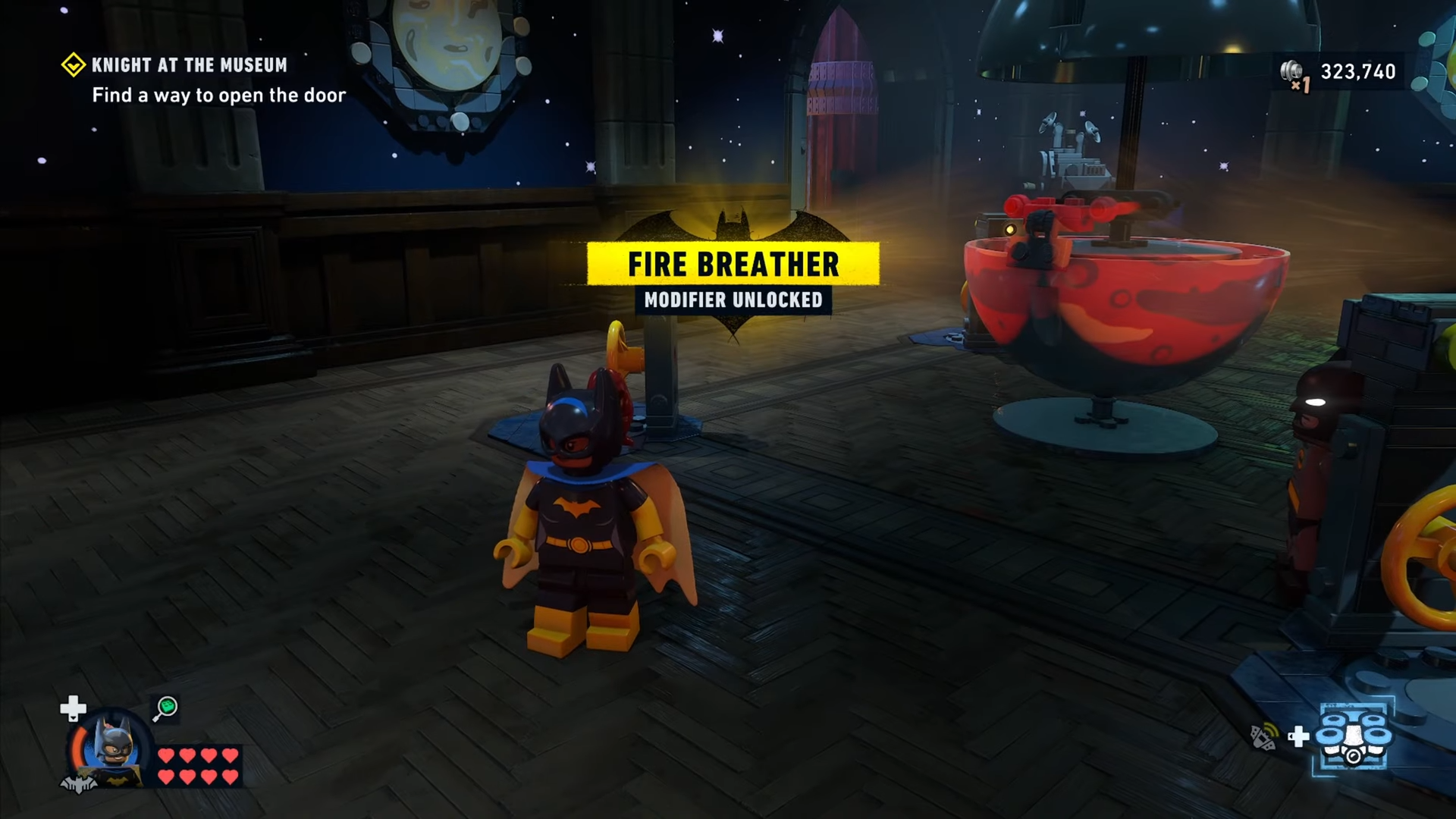 Character grabs the red brick in Knight at the Museum mission in Lego Batman: Legacy of the Dark Knight and unlocks the Fire Breather modifier.