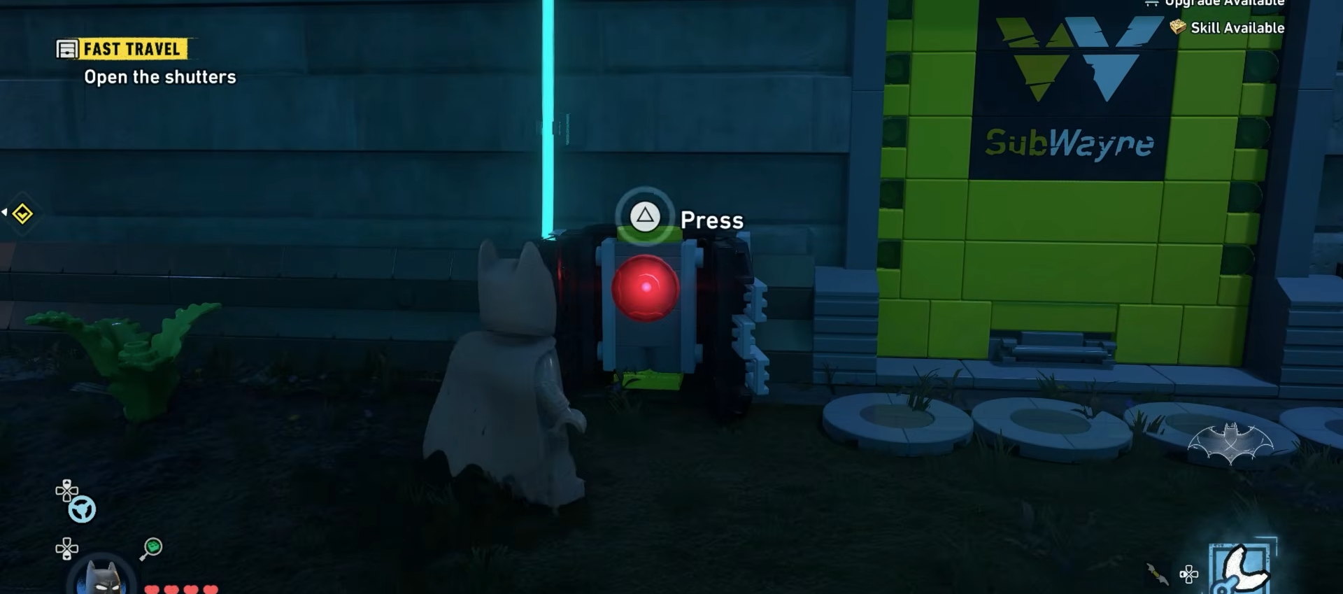Batman pressing the red button to open the shutters at Newtown in Lego Batman Legacy Of The Dark Knight