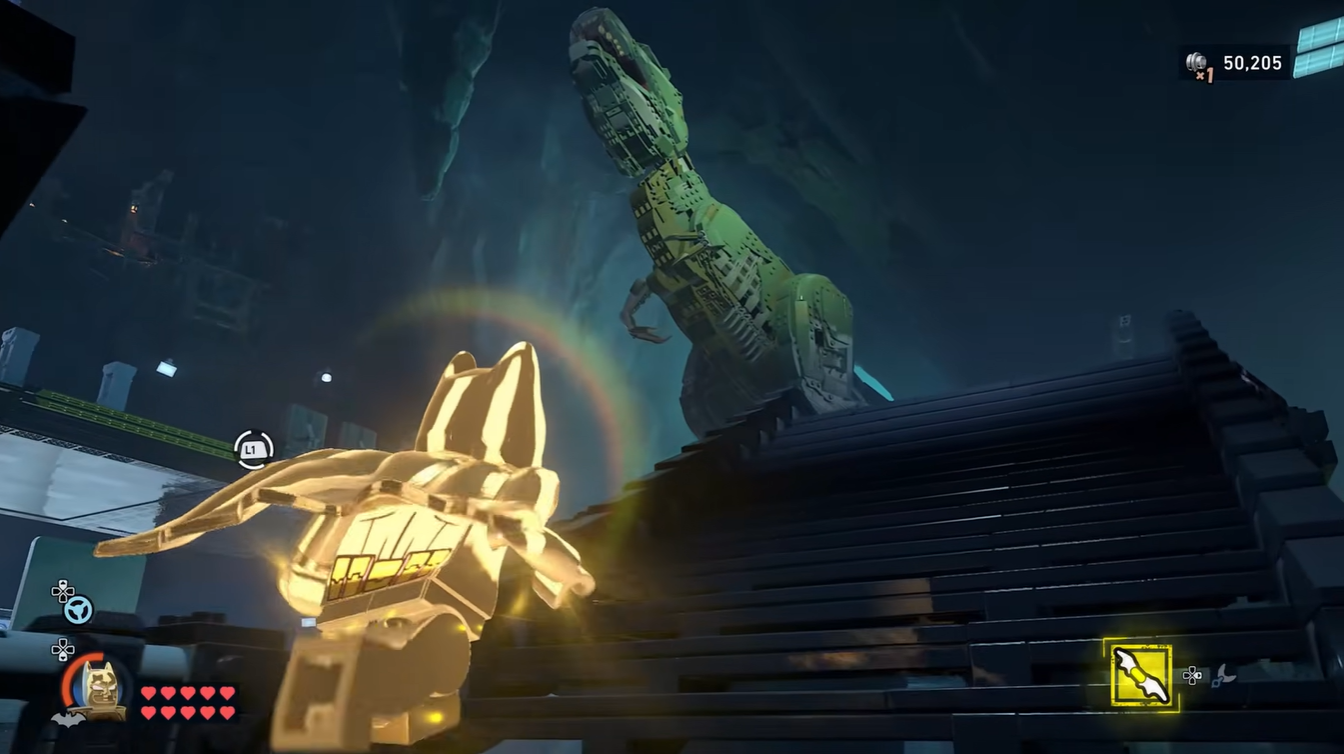 Batman reaching to the T-Rex Model inside the Batcave in LEGO Batman: Legacy of the Dark Knight