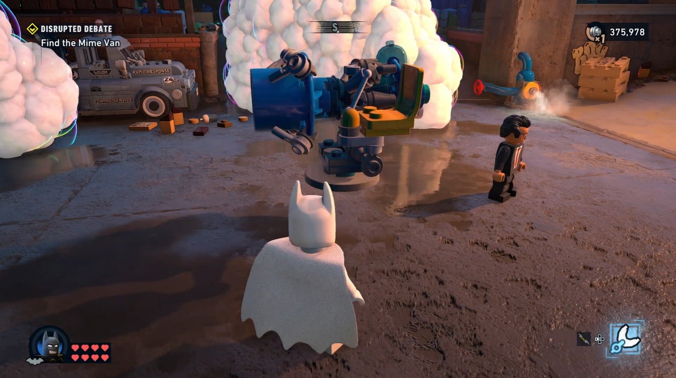 Building the soap cannon beside the foam-covered vehicles