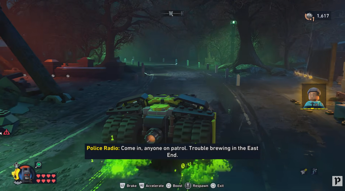 Batman traveling through East End Amusement Mile toward the Arkham Asylum road in LEGO Batman Legacy of the Dark Knight