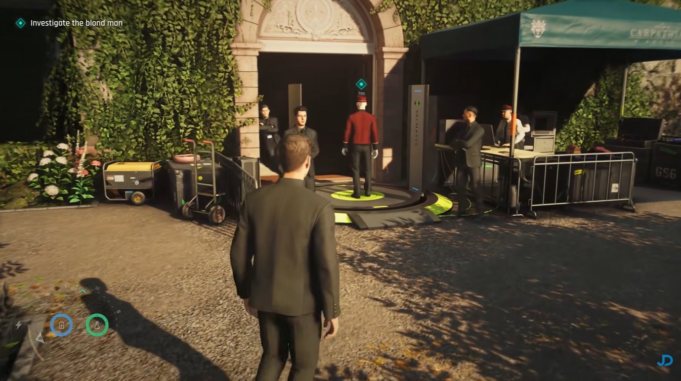Bond observing the blonde man near the hotel entrance in 007 First Light