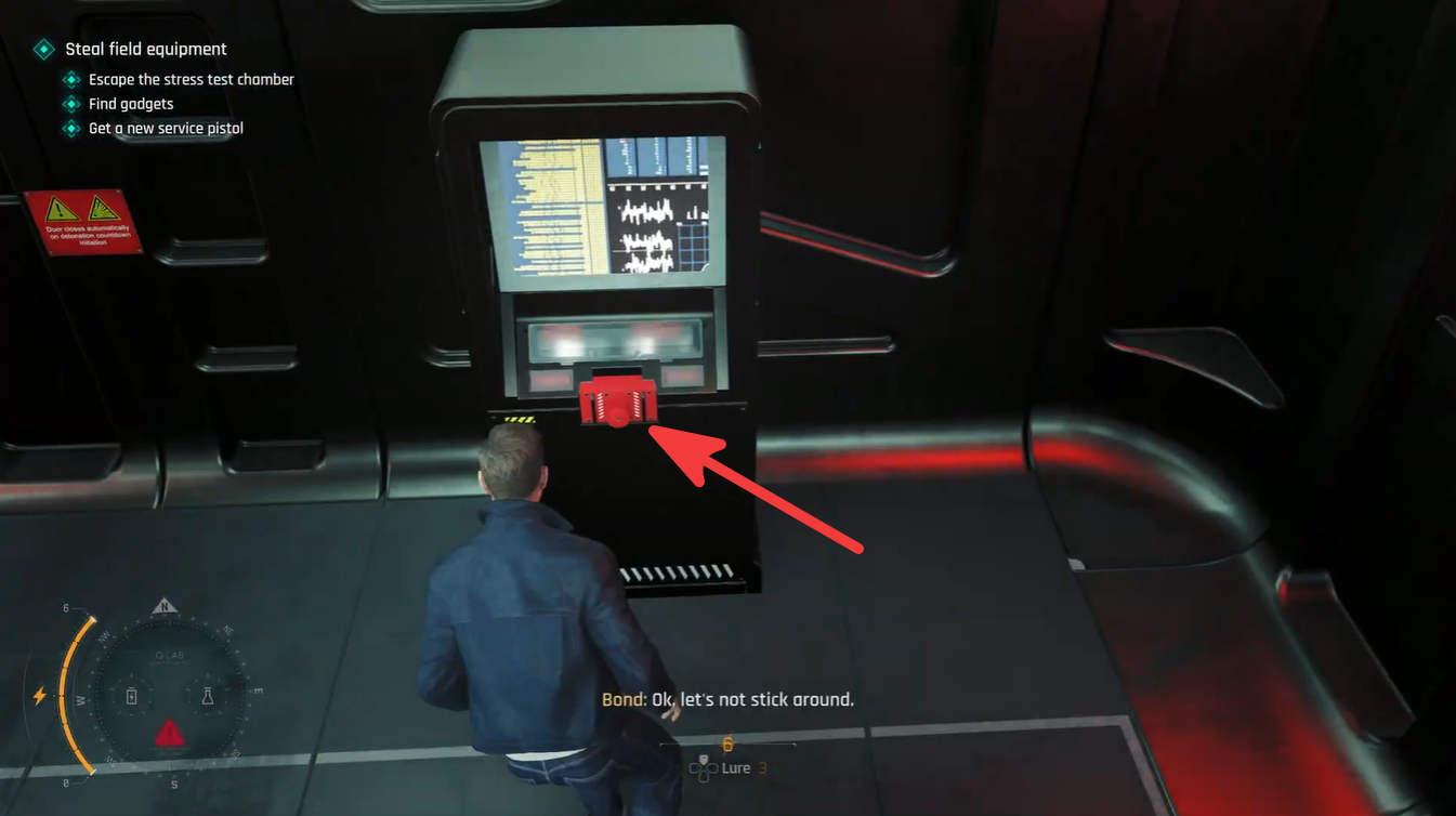 Close-up of the terminal-mounted red activation switch used to start the explosion test sequence in the Stress Test Chamber.