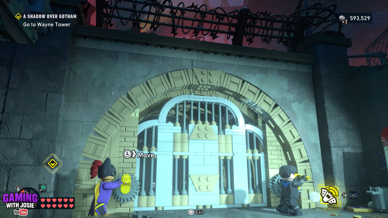 Batgirl approaching the first gate area with enemies in A Shadow Over Gotham