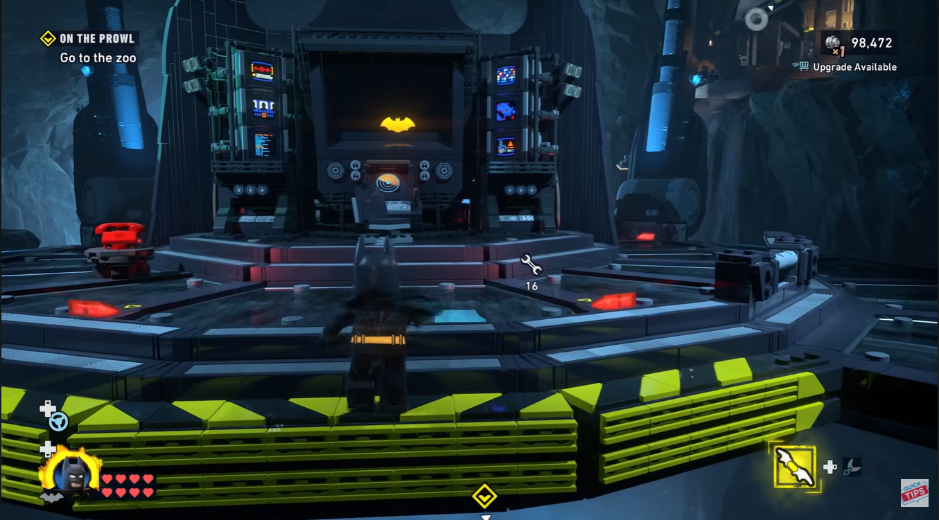Batman standing near the Batcomputer terminal inside the Batcave hub in LEGO Batman Legacy of the Dark Knight