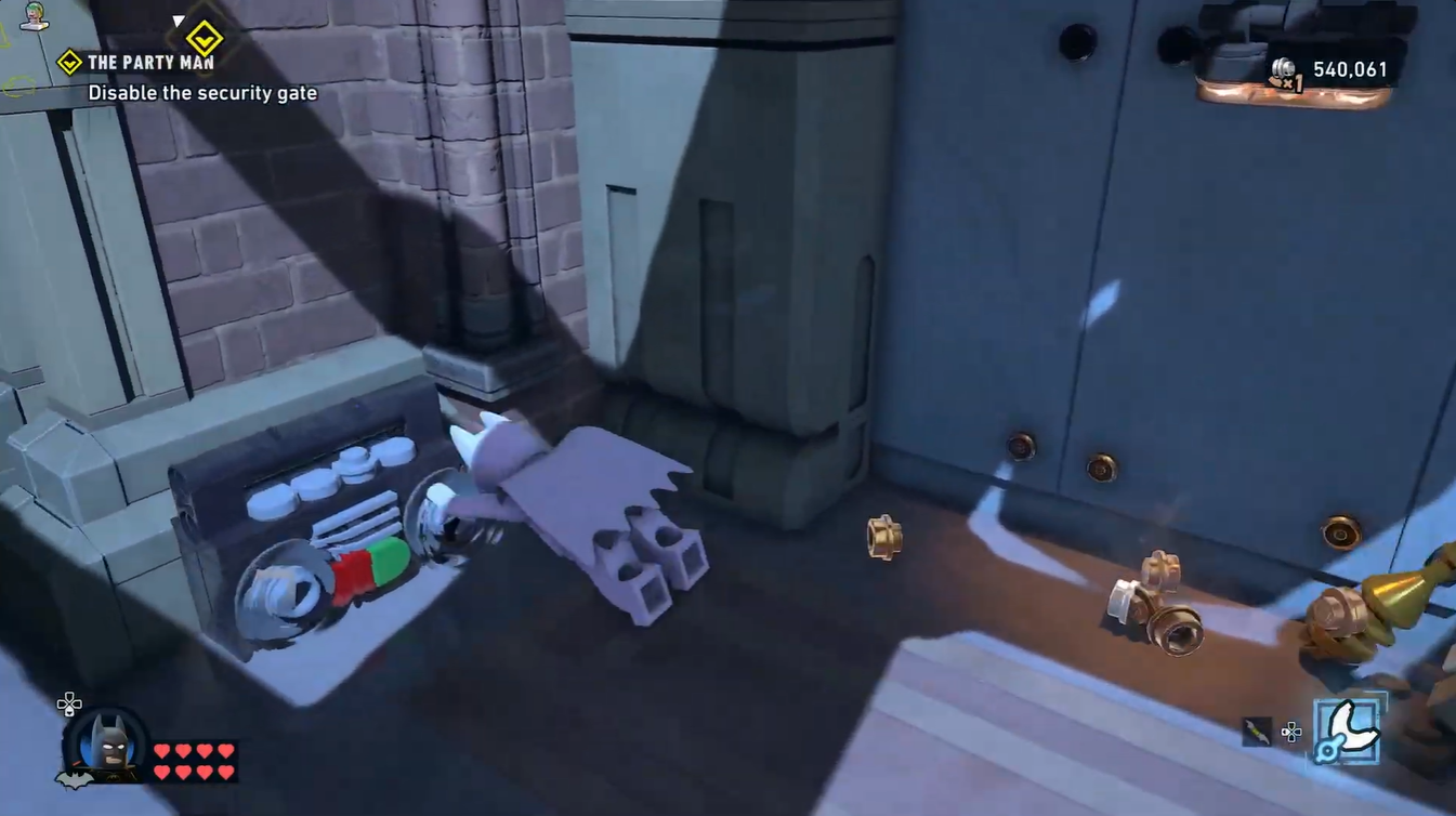 Second boombox collectible hidden underneath the staircase after opening the secret gate in LEGO Batman Party Man.