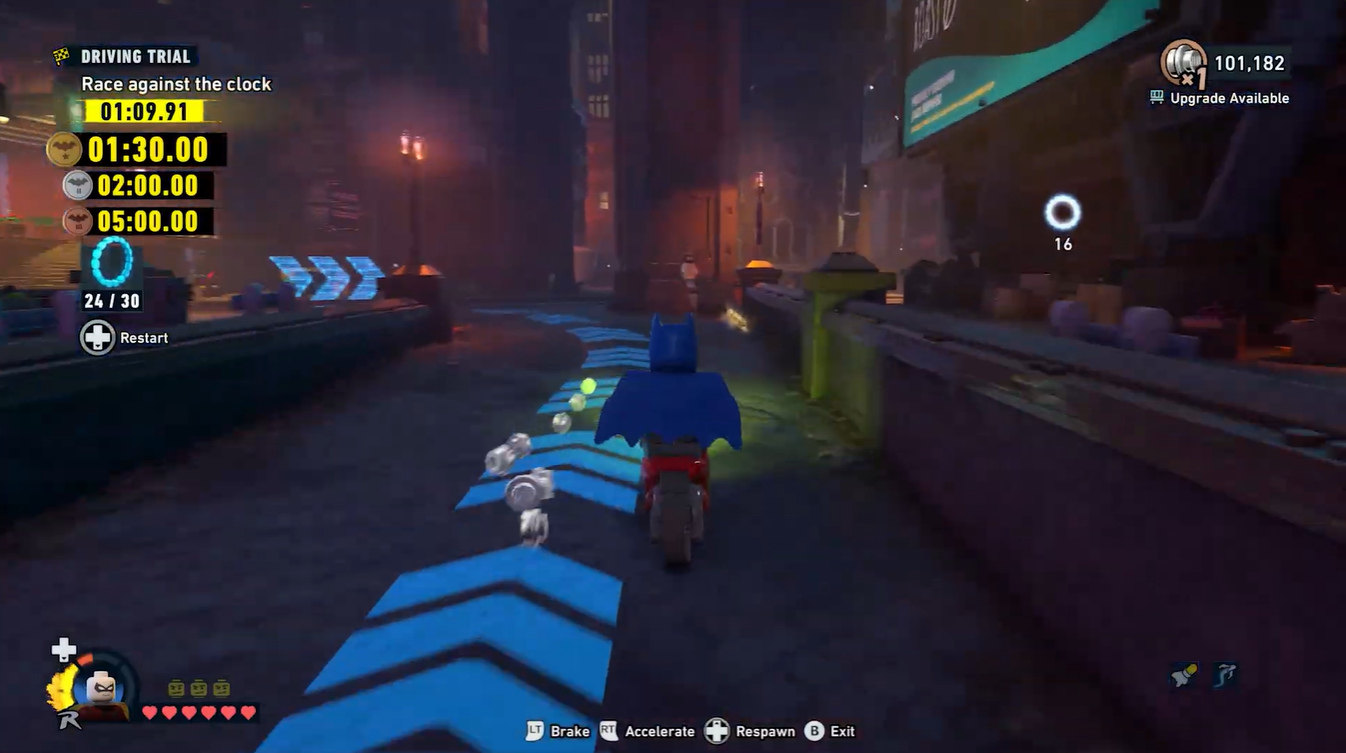 Batman collecting studs on vehicle in LEGO Batman Legacy of the Dark Knight