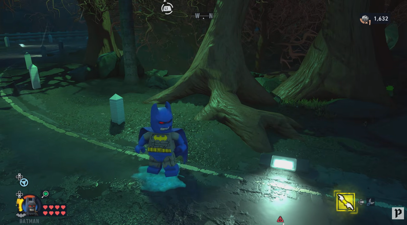 Batman standing directly on the glowing ectoplasm puddle before activating Photo Mode in LEGO Batman Legacy of the Dark Knight