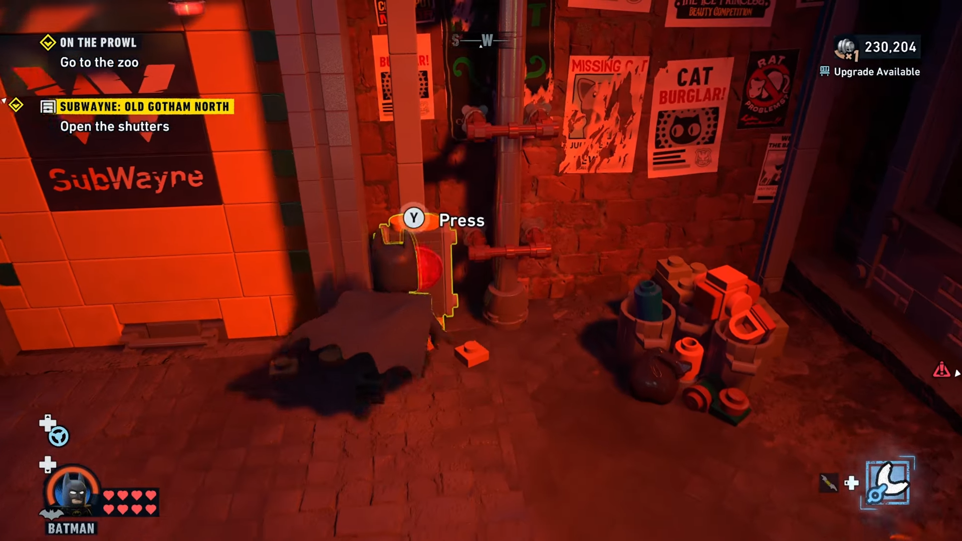 Batman pressing the button in front of the Subwayne tunnel at Old Gotham North to open the shutters in Lego Batman: Legacy Of The Dark Knight: 