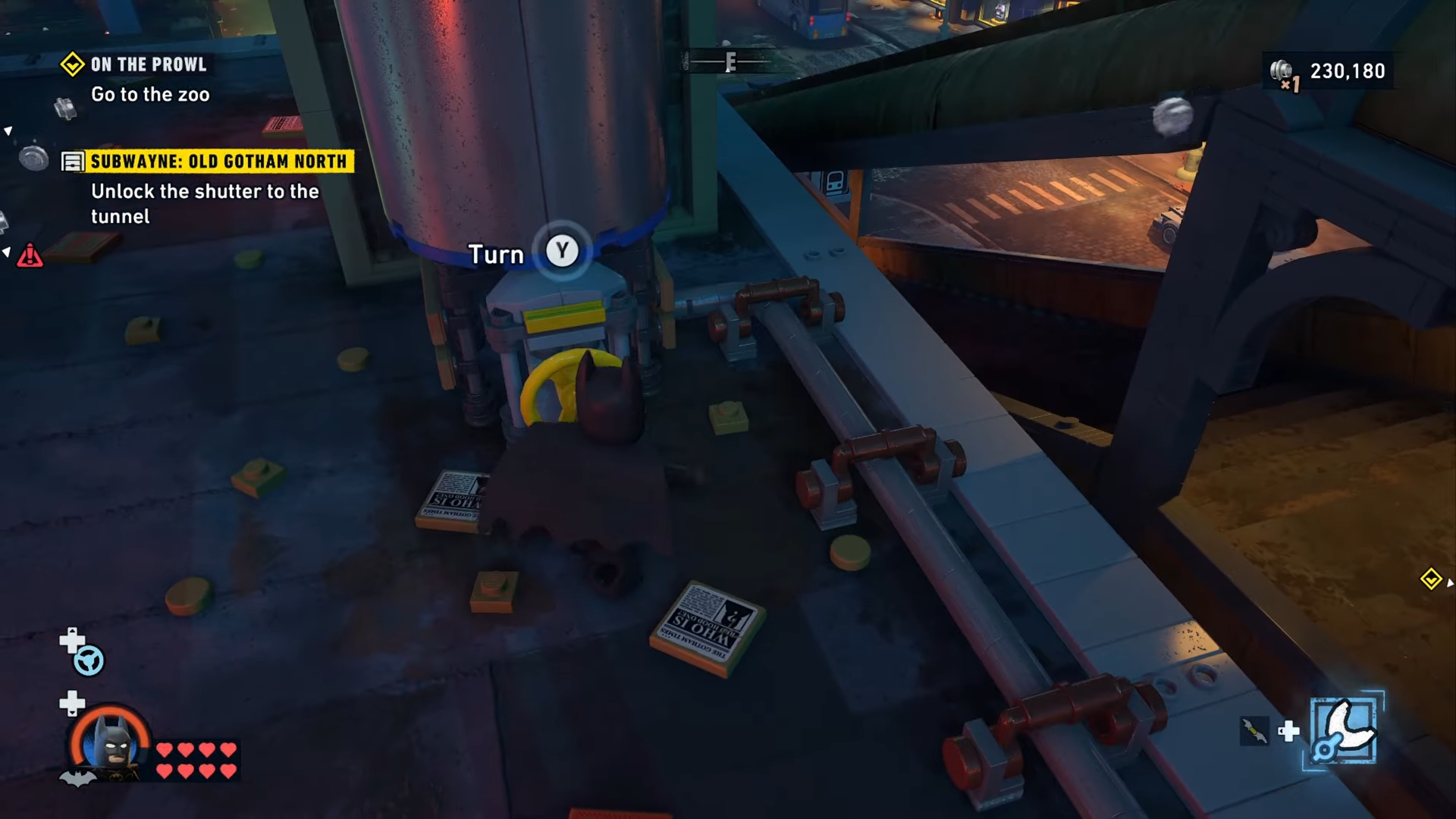 Batman turning the pipe wheel on top of the building at Old Gotham North in Lego Batman: Legacy Of The Dark Knight: