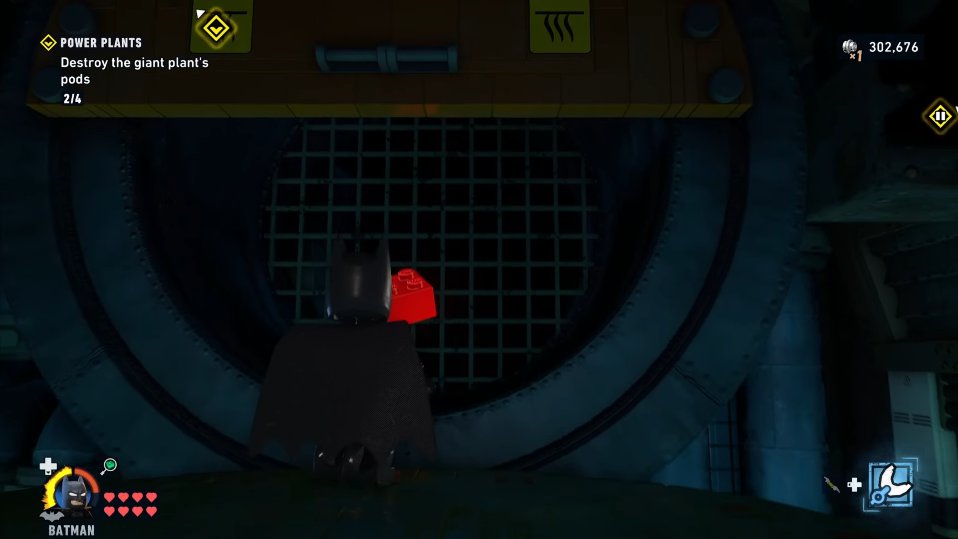 Batman stands before the red brick in Power Plants mission in Lego Batman: Legacy of the Dark Knight.
