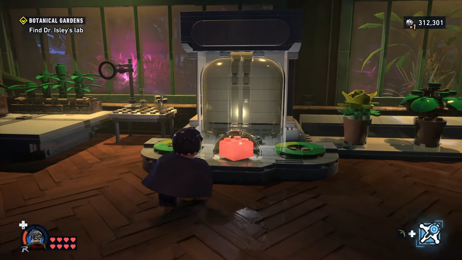 Robin standing before the red brick housed behind a glass mechanism in Botanical Gardens in Lego Batman: Legacy of the Dark Knight.