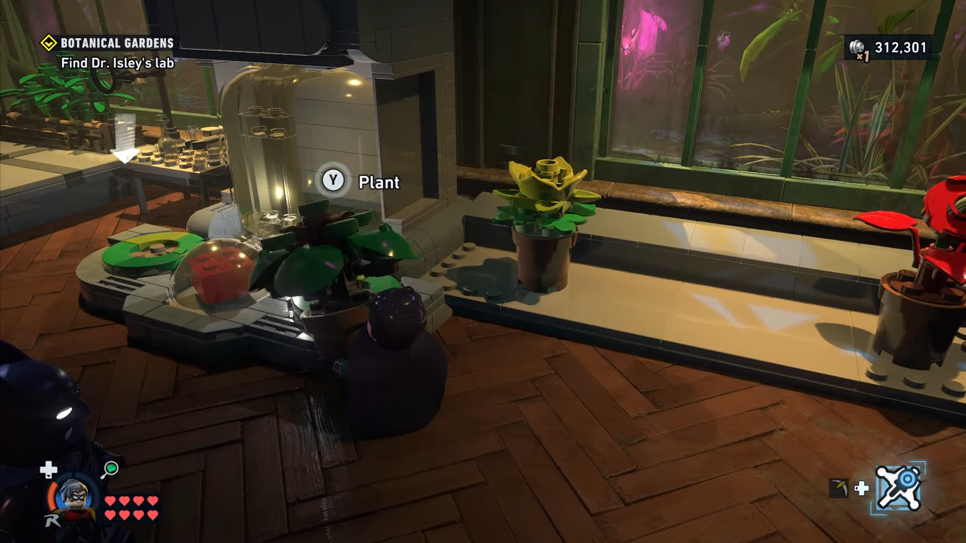 Robin placing the green plant to the right of the red brick mechanism in Botanical Gardens in Lego Batman: Legacy of the Dark Knight.