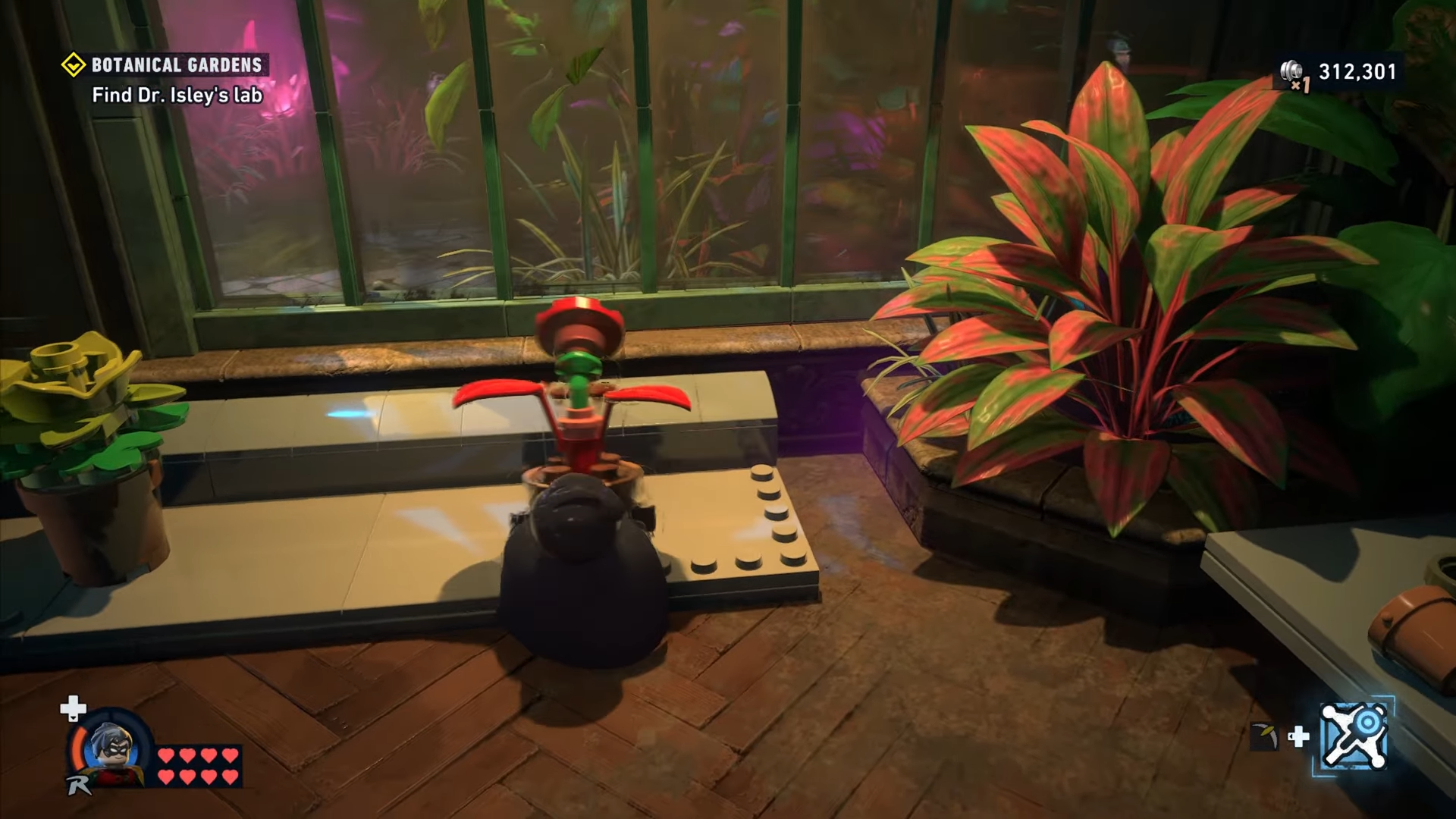 Robin picking up the red plant in Botanical Gardens in Lego Batman: Legacy of the Dark Knight.