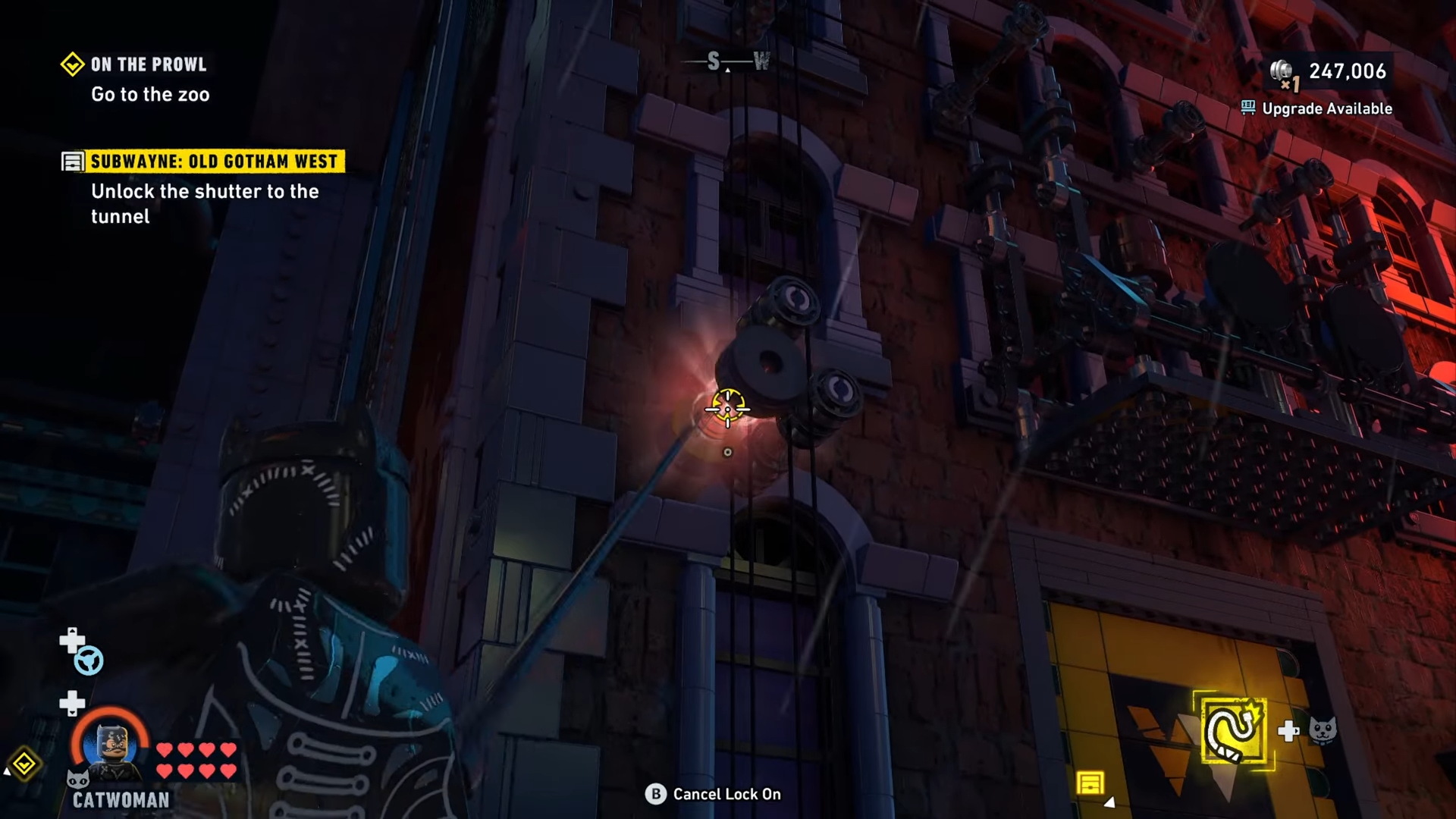 Catwoman using her whip to hit the pulley mechanism on top of the graffiti artists in Lego Batman: Legacy of the Dark Knight