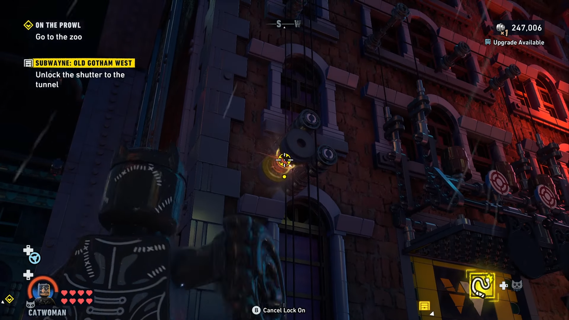 Catwoman's whipping causing the second part of the mechanism to come down above the graffiti artists in Lego Batman: Legacy of the Dark Knight