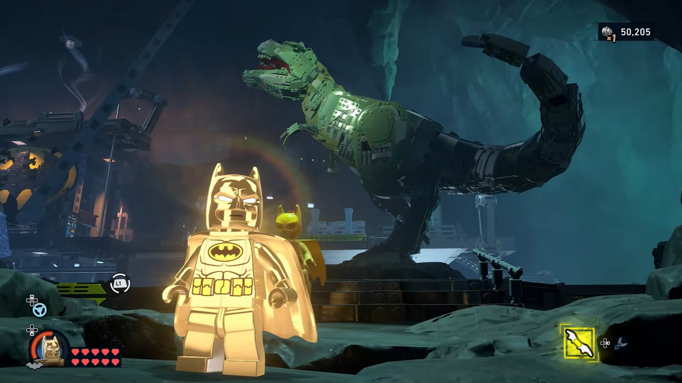 Batman standing in front of the T-Rex Model inside the Batcave in LEGO Batman: Legacy of the Dark Knight