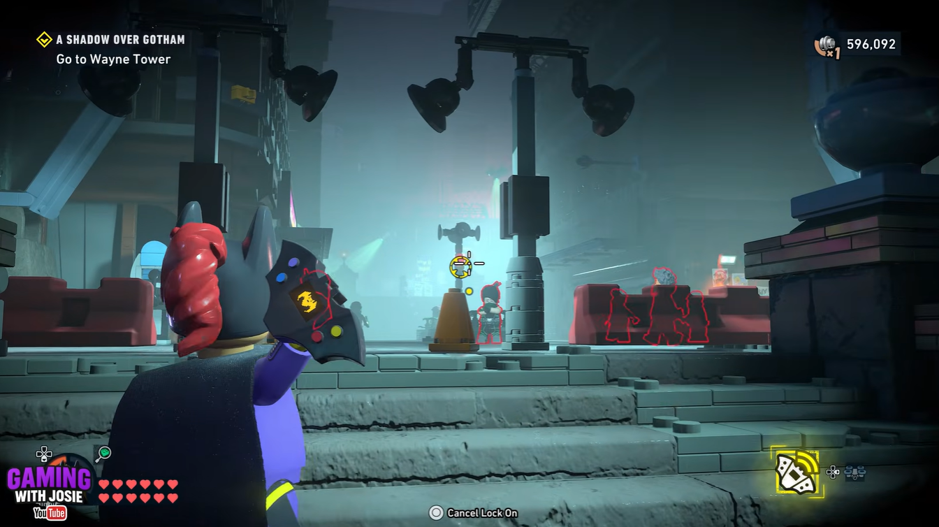 Batgirl throwing a Hackarang at the distant hackable terminal to distract enemies