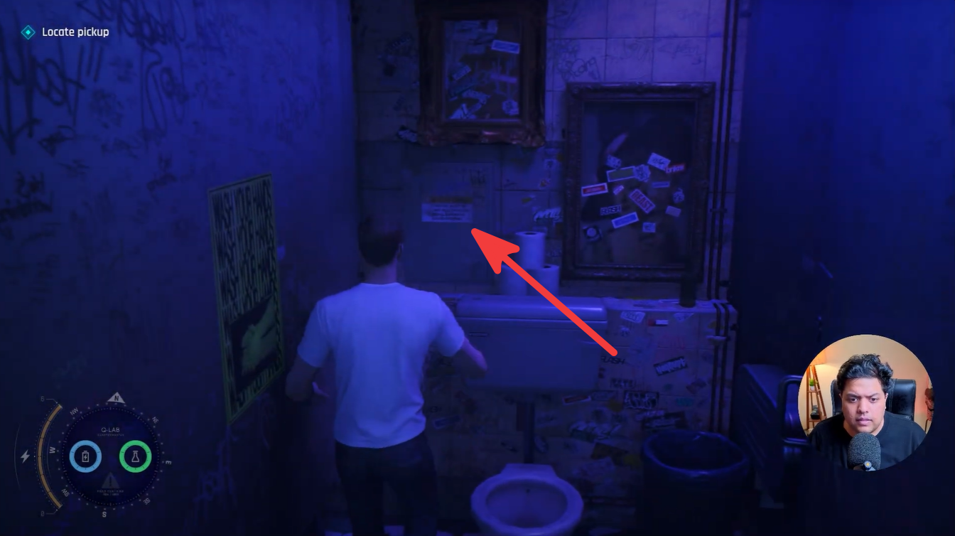 The hidden pickup is concealed behind a small wall cabinet above the sink inside the restroom. Open the cabinet to retrieve the package and progress the mission.