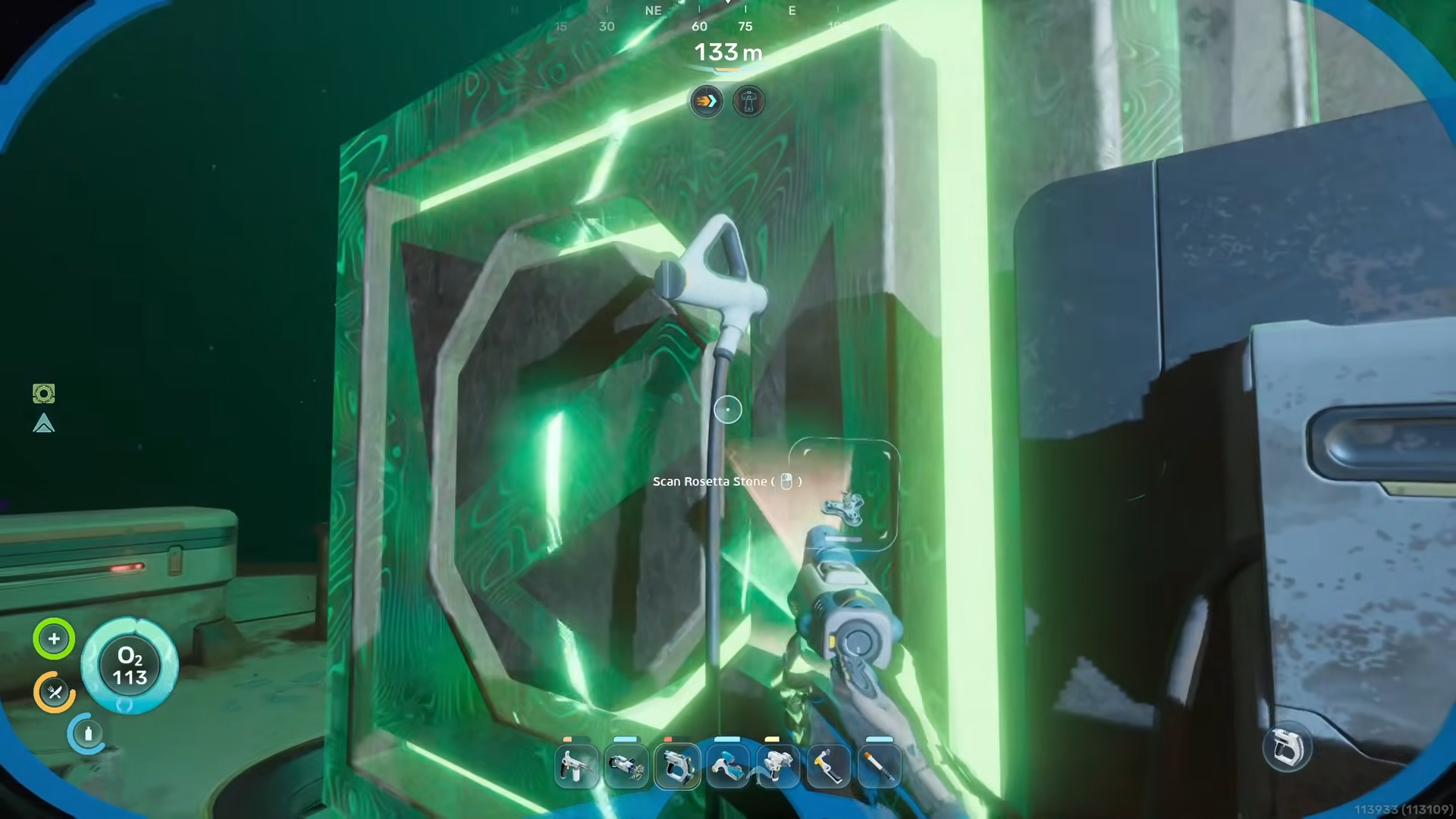 Scanning the glowing green Axum Rosetta Stone monolith inside the alien ruins in Subnautica 2.