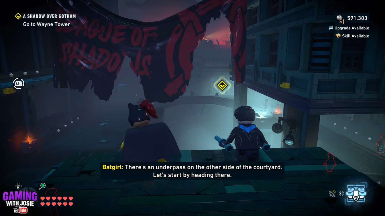 Batgirl standing inside the Batcave Case Log menu before replaying A Shadow Over Gotham in LEGO Batman Legacy of the Dark Knight