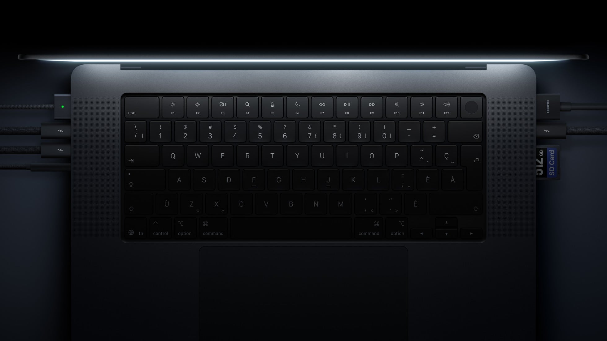 A close-up of the keyboard and ports on MacBook Pro with PROLED XDR Display